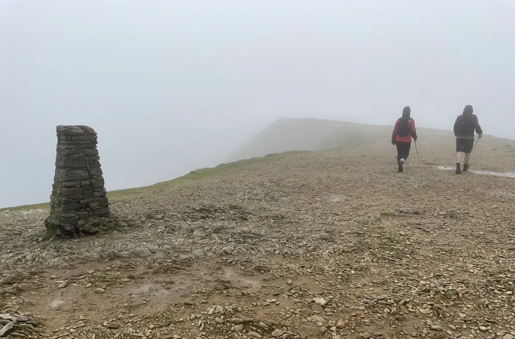 Walkers on a foggy Helvellyn summit